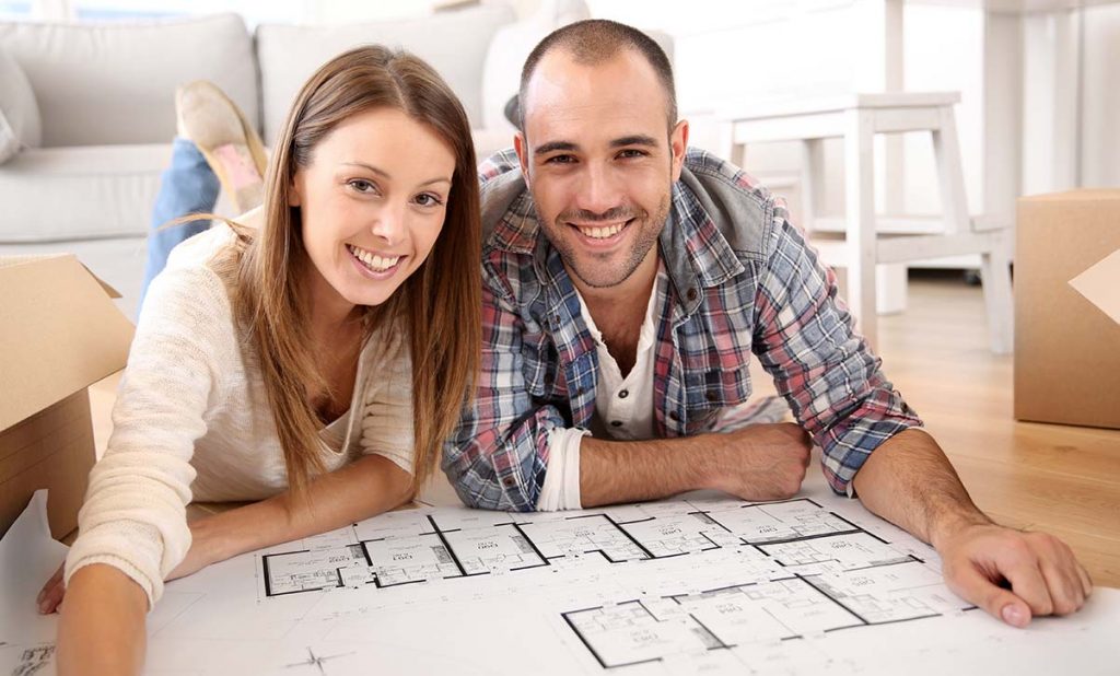 Young Couple Looking at Construction Documents