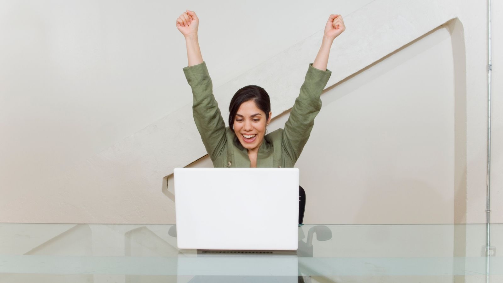 Woman who is excited about getting qualified through the RefiNow program offered by Fannie Mae.